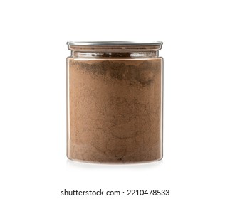 Transparent Jar Full Of Ground Cinnamon On A White Background. Copy Space.