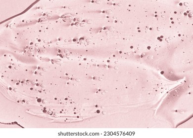 Transparent liquid cream texture on a pink background, macro, top view.Peeling gel for beauty procedures. - Shutterstock ID 2304576409