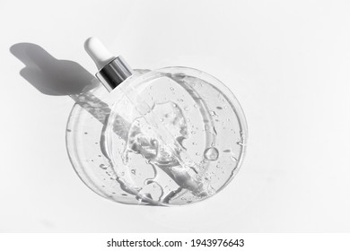 Transparent liquid gel or hyaluronic serum acid in petri medical dish with pipette. Hydrating and skin care concept - Shutterstock ID 1943976643