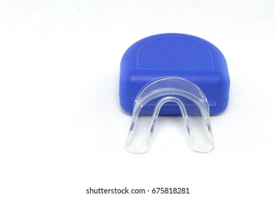 Transparent Mouth Guard And Blue Case On White Background