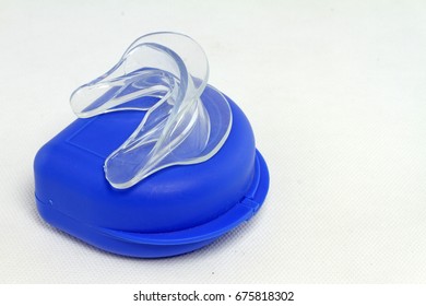 Transparent Mouth Guard And Blue Case On White Background