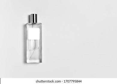 Transparent perfume bottle Mock-up with blank label isolated on a white background. High resolution photo.