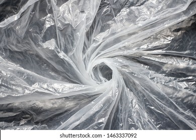 Transparent Plastic Bag Swirl. Whirlpool From Clear Plastic Bag. Background Texture. Waste Recycle. Reuse Of Trash.