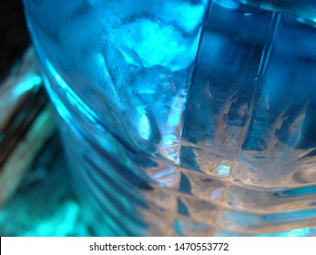 Transparent Plastic Canister With Blue Automobile Liquid (blue Non-freezing Liquid) On The Porch On The Threshold Of The House. On The Bottle Are Located Transverse Swathe Of. Game Of Light Spots. 