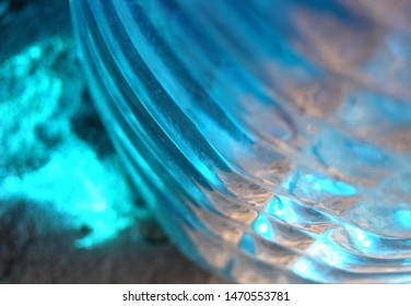 Transparent Plastic Canister With Blue Automobile Liquid (blue Non-freezing Liquid) On The Porch On The Threshold Of The House. On The Bottle Are Located Transverse Swathe Of. Game Of Light Spots.  