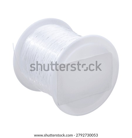 Transparent plastic spool of beading thread on white background, clear nylon fishing line roll isolated for jewelry making and craft needlework