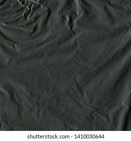 Transparent Plastic Wrap On The Black Background. Plastic Bag Texture. Reusable Trash And Waste.