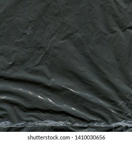 Transparent Plastic Wrap On The Black Background. Plastic Bag Texture. Reusable Trash And Waste.