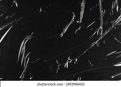 Transparent plastic wrap on the black background. Clean blank texture overlay effect template. Isolated wrinkle surface branding mock-up. - Shutterstock ID 1893984433