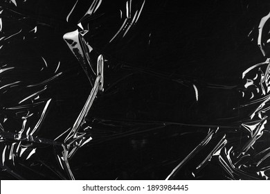 Transparent plastic wrap on the black background. Clean blank texture overlay effect template. Isolated wrinkle surface branding mock-up. - Shutterstock ID 1893984445