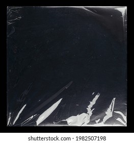 Transparent plastic wrap on the black background. Clean blank texture overlay effect template. Isolated wrinkle surface branding mock-up template.