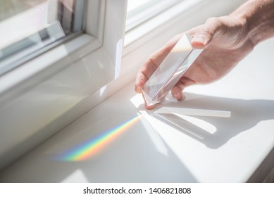 Transparent prism for light education expriments in a man's'hand - Powered by Shutterstock