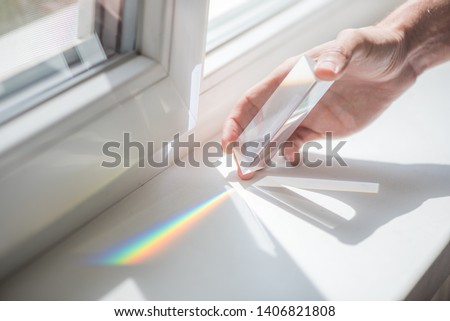 Transparent prism for light education expriments in a man's'hand
