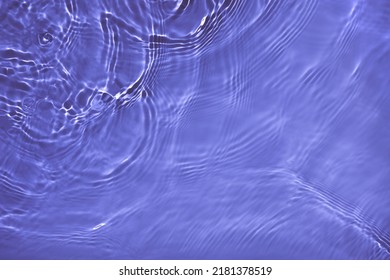 Transparent purple water surface texture with ripples, splashes and bubbles. Abstract nature background Water waves in sunlight with copy space Cosmetic moisturizer micellar toner emulsion. 2022 color - Shutterstock ID 2181378519