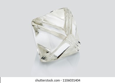 Transparent rough diamond isolated on white background.