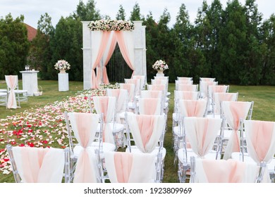 Transparent stylish plastic chairs. Luxury decor for the white wedding ceremony.