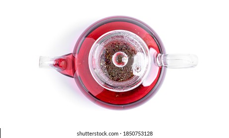 Transparent teapot with red tea on a white background. View from the top. High quality photo