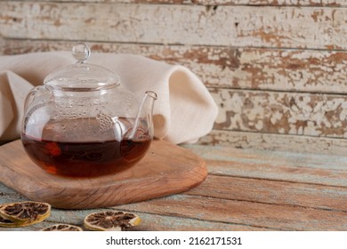 Transparent teapot and tea in a glass. blur background.
