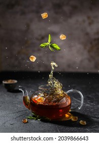 transparent teapot with tea on a dark background. High quality photo