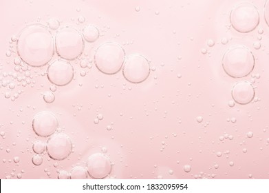 Transparent texture of moisturizing serum on a pink background. Gel water lotion for skincare. Cosmetic liquid beauty product with retinol and vitamins for face and body skin care. - Shutterstock ID 1832095954