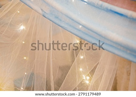Transparent tulle with garland lights to complement the interior