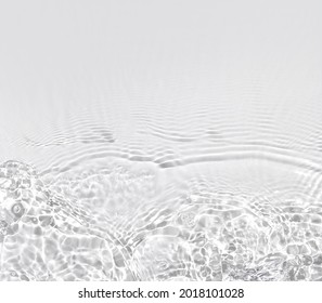 Transparent water surface with ripples and splashes. Summer water waves background in sunlight. copy space - Shutterstock ID 2018101028