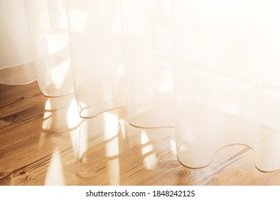 Transparent white curtain tulle from an open window. Sunny day, the sun's rays sunlight penetrate the room. - Shutterstock ID 1848242125