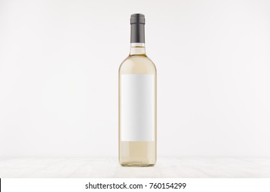 Transparent White Wine Bottle With Blank White Label On White Wooden Board, Mock Up. 