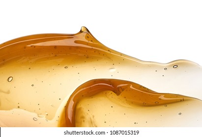 Transparent yellow smear of face cream or golden honey isolated on white background. Golden creamy honey texture on white background