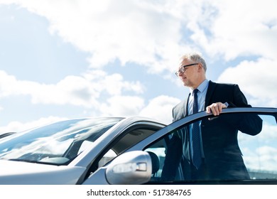 Transport, Business Trip And People Concept - Senior Businessman Getting Into Car