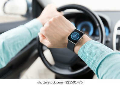 transport, business trip, technology, time and people concept - close up of man with wristwatch or smart watch driving car