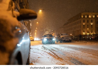 Transport collapse on road at night during winter snowfall, snow blizzard causes huge traffic jam in European city, snowy road with many cars stacked on road, evening roadway in snowstorm
