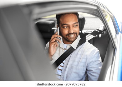 transport, communication and people concept - happy smiling indian male passenger or businessman calling on smartphone on back seat of taxi car