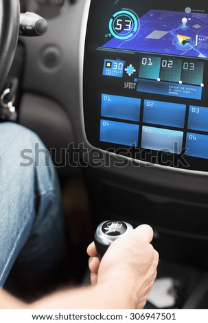 transport, destination, modern technology and people concept - male hand on gearshift and navigation system on car dashboard screen