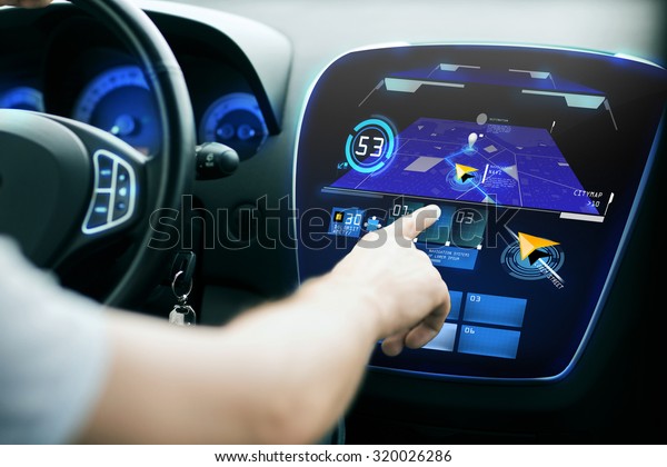 transport, destination, modern technology and\
people concept - male hand searching for route using navigation\
system on car dashboard\
screen