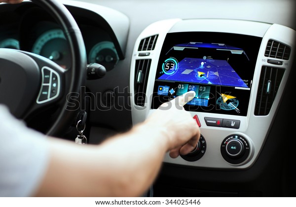 transport, destination, modern technology and\
people concept - male hand searching for route using navigation\
system on car dashboard\
screen