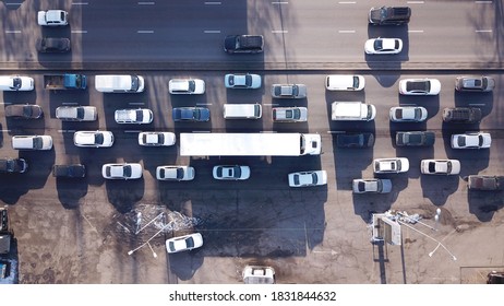 Transport Interchange In A Big City. Long Traffic Jam. A Huge Number Of Cars Pass By. A Large Trucker's Truck Is Visible. Muddy Roads, Heavy Car Exhaust. Bad Ecology Of The City Of Almaty.