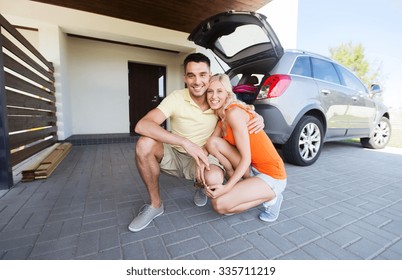 Transport, Leisure, Family And People Concept - Happy Couple Hugging At Home Car Parking Space