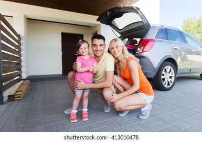 Transport, Leisure, Road Trip And People Concept - Happy Family With Little Girl And Hatchback Car At Home Parking Space