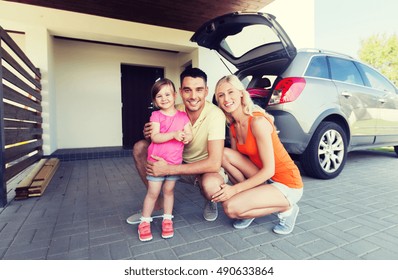 Transport, Leisure, Road Trip And People Concept - Happy Family With Little Girl And Hatchback Car At Home Parking Space