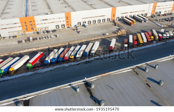 transport near the cargo\
terminal covered with snow, delivery of groceries and goods.  View\
from drone