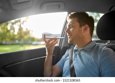 Transport, Technology And Communication Concept - Male Passenger Using Voice Command Recorder On Smartphone On Back Seat Of Taxi Car