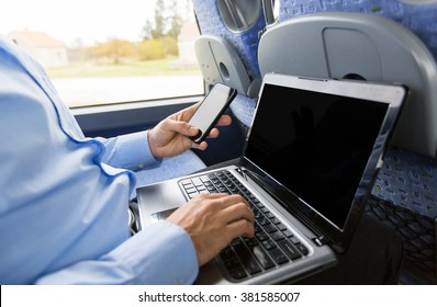 Transport, Tourism, Business Trip And People Concept - Close Up Of Man With Smartphone And Laptop In Travel Bus