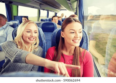 Transport, Tourism, Friendship, Road Trip And People Concept - Young Women Or Teenage Friends Riding In Travel Bus