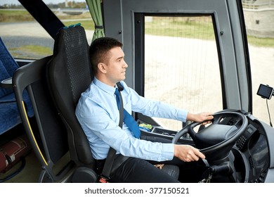 transport, tourism, road trip and people concept - happy driver driving intercity bus - Shutterstock ID 377150521