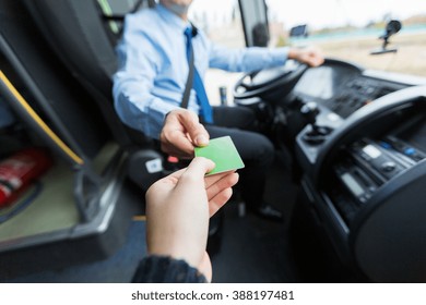 transport, tourism, road trip and people concept - close up of bus driver taking ticket or plastic card from passenger