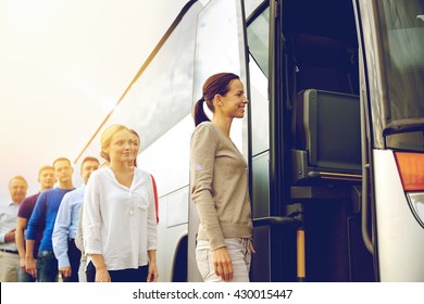 Transport, Tourism, Road Trip And People Concept - Group Of Happy Passengers Boarding Travel Bus