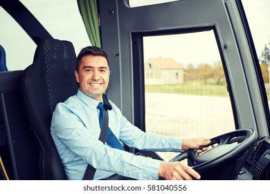 Transport, Tourism, Road Trip And People Concept - Happy Driver Driving Intercity Bus