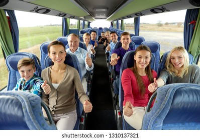 Transport, Tourism And Travel Concept - Group Of Happy Passengers Travelling By Bus And Showing Thumbs Up