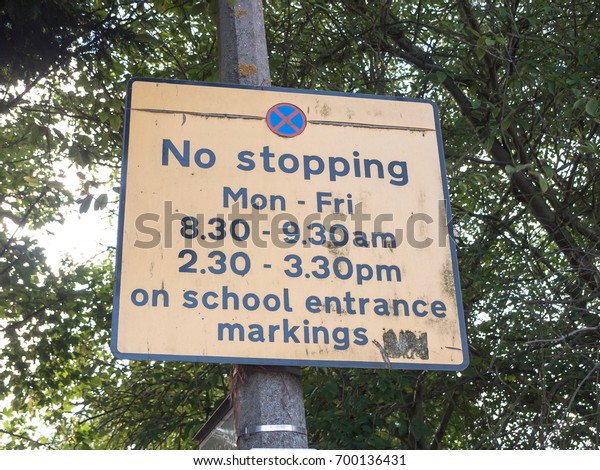 transport and traffic sign outside school yellow no\
stopping; England; UK
